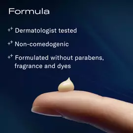 A small dollop of cream on a fingertip and text listing formula claims: dermatologist tested, non-comedogenic, and formulated without parabens, fragrance, and dyes.