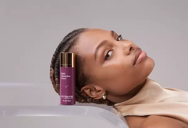 New - Ampra Volumizing Macro HA Serum - purple bottle on clear table with person