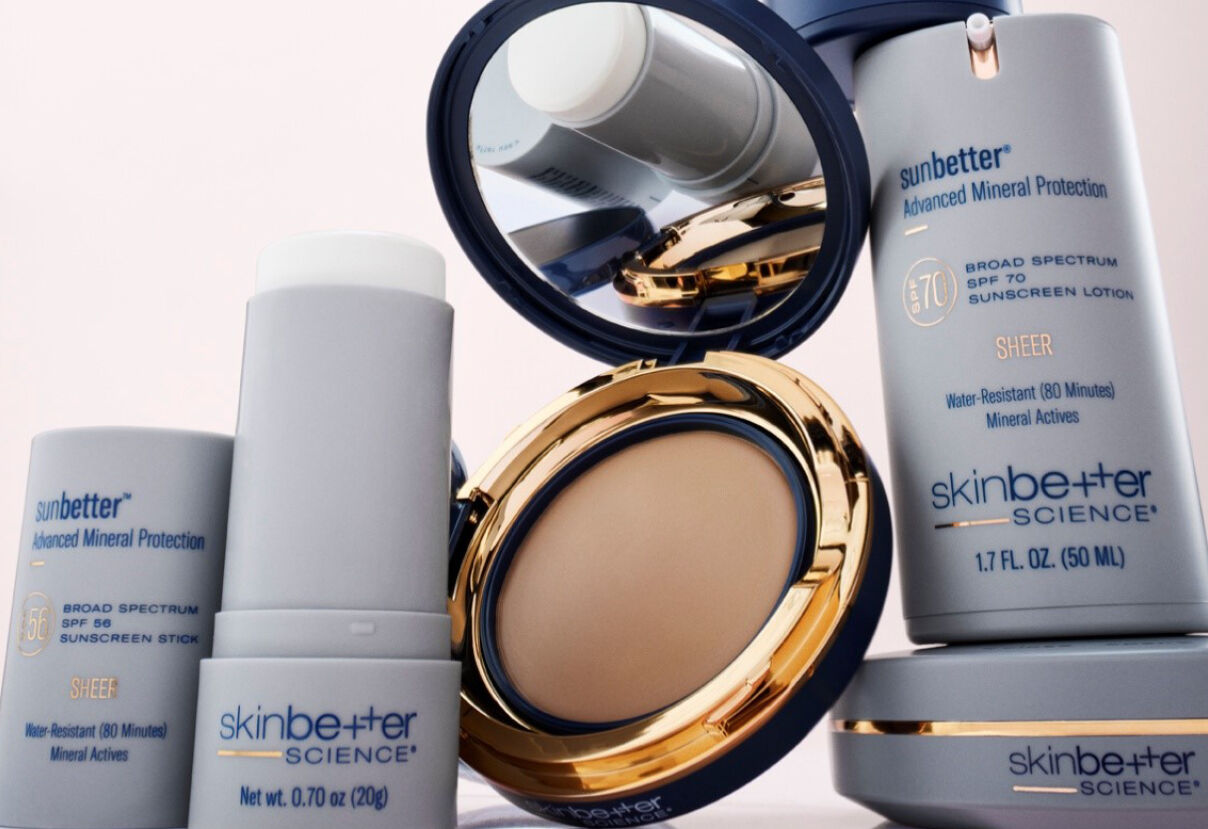 skinbetter science mineral sunscreen products beside an open gold compact mirror revealing pressed powder